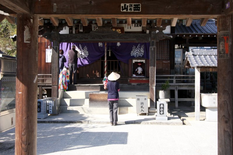 石垣を積んだ高台の上に境内がある。小山を背に諸堂が建っている。 