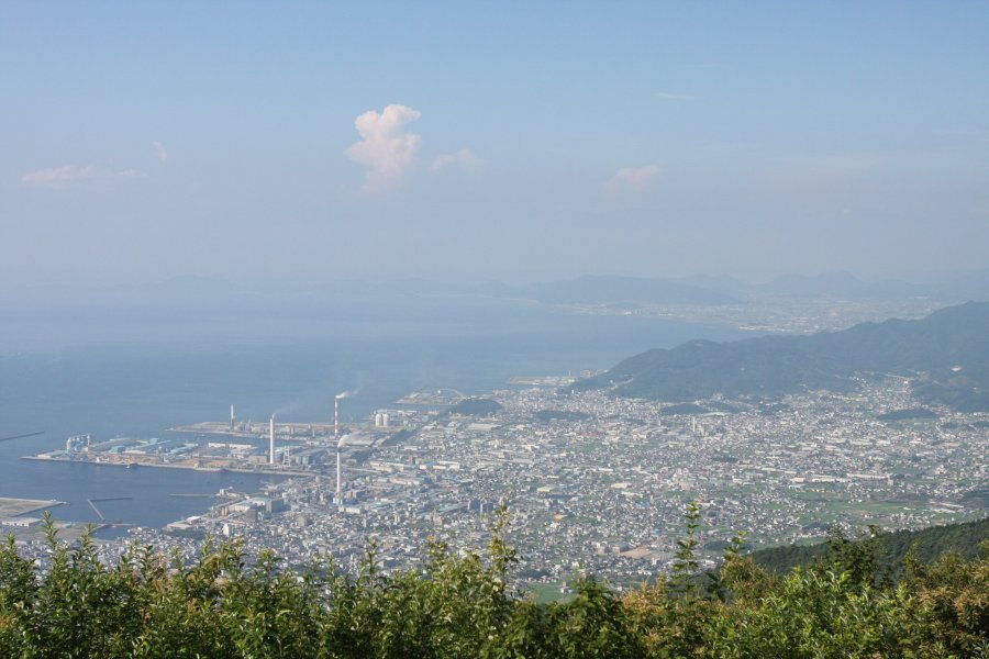 標高892mの翠波峰からは、遮るものがなく360度の大パノラマが広がる。眼下には旧伊予三島の町が望め、製紙工場の煙突から立ち上る煙も見える。