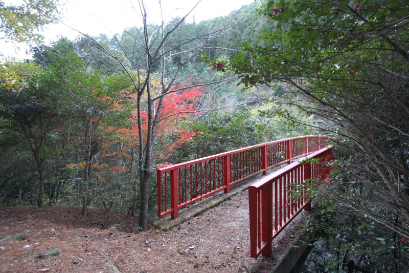 渓谷にかかる赤い橋は遊歩道へと続いており、秋には紅葉した木々をくぐり抜けながら散策が楽しめる。